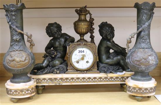A French Art Nouveau bronzed spelter and marble three piece clock garniture, clock 20in.